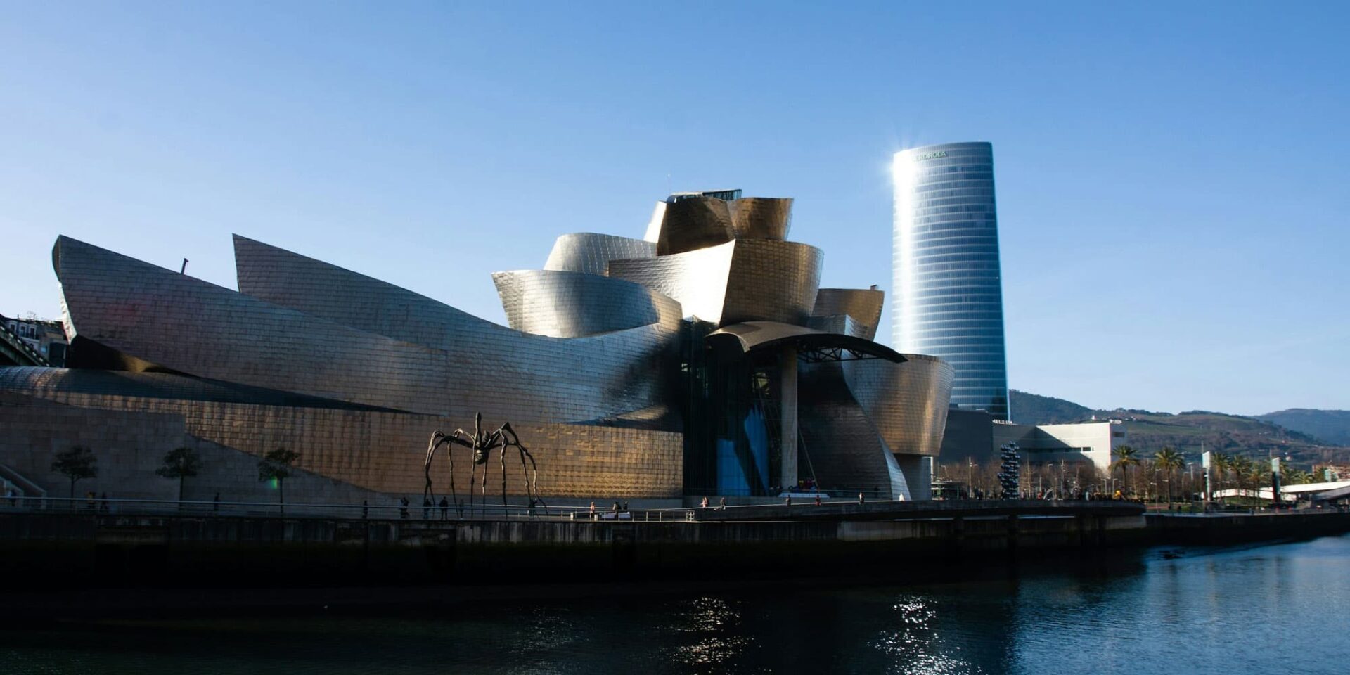 Guggenheim Museum Bilbao and tower on clear day.