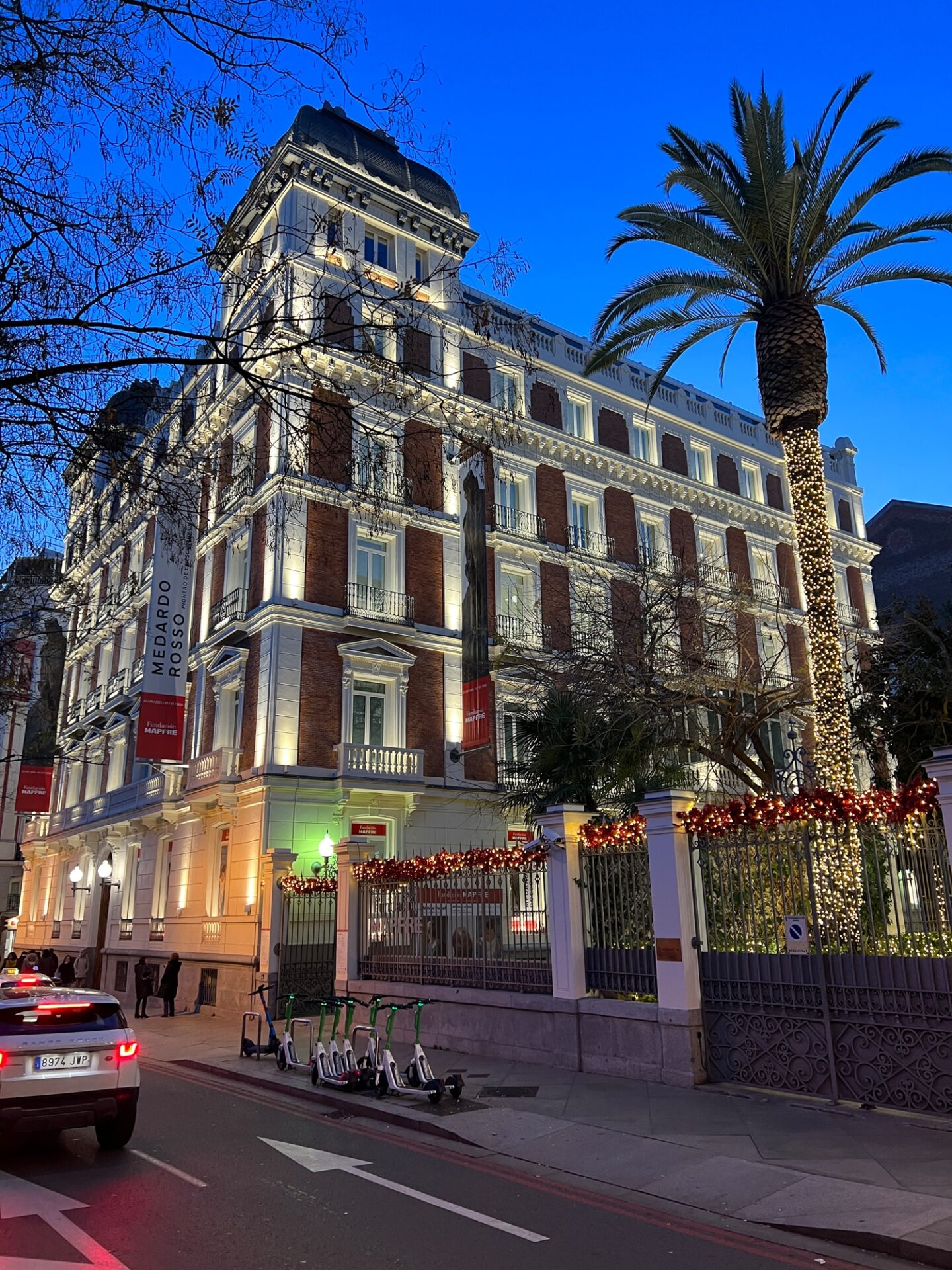 Historic building facade with holiday decorations at dusk.